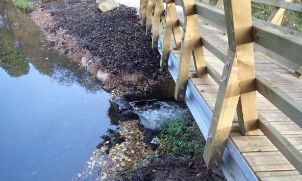 A steel beamed bridge with splayed out parapets for a biking trail