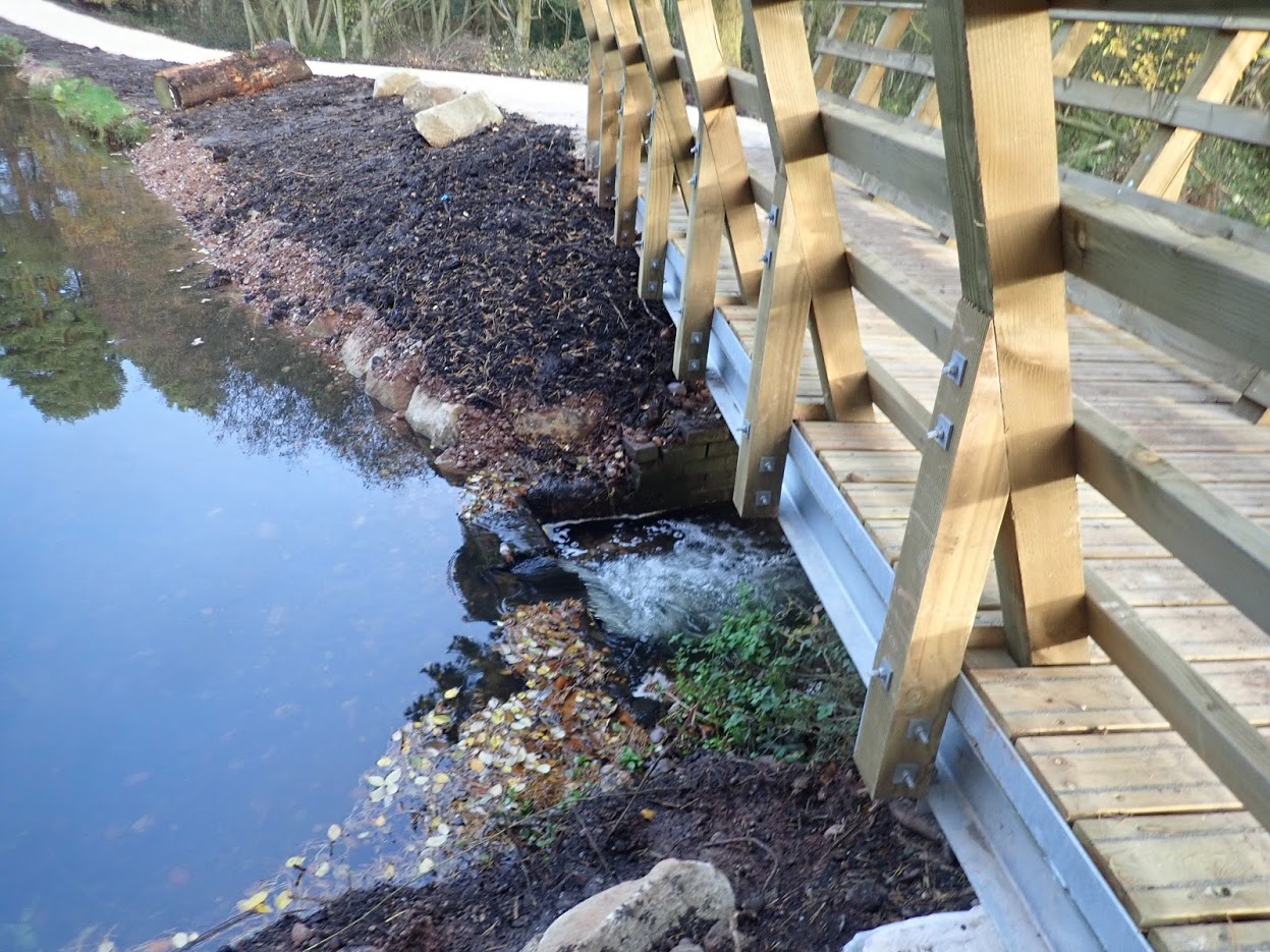 A steel beamed bridge with splayed out parapets for a biking trail