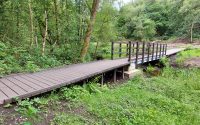 the start of a boardwalk in the countryside, across marsh wetlands