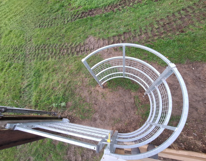 a steel kissing gate that allows people through but not livestock