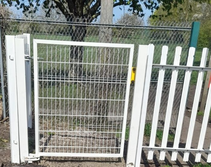 White steel pedestrian gate for use at a rail crossing