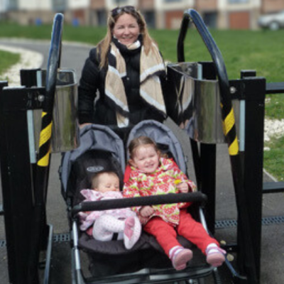 Twin buggy passing through a Dual Adjustment K Barrier on a public footpath