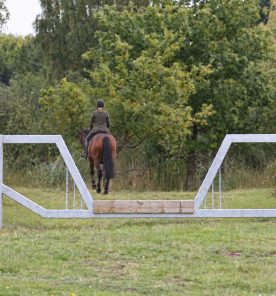 horse friendly vehicle barrier gate on a bridleway with horse and rider