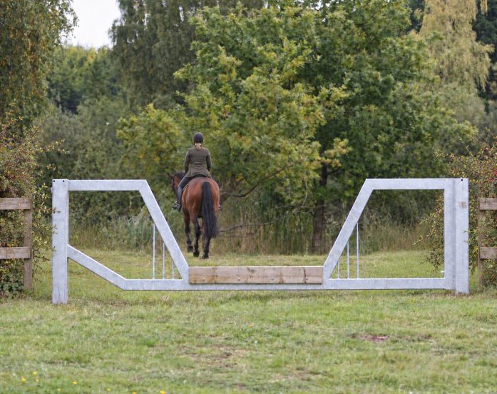 horse friendly vehicle barrier gate on a bridleway with horse and rider